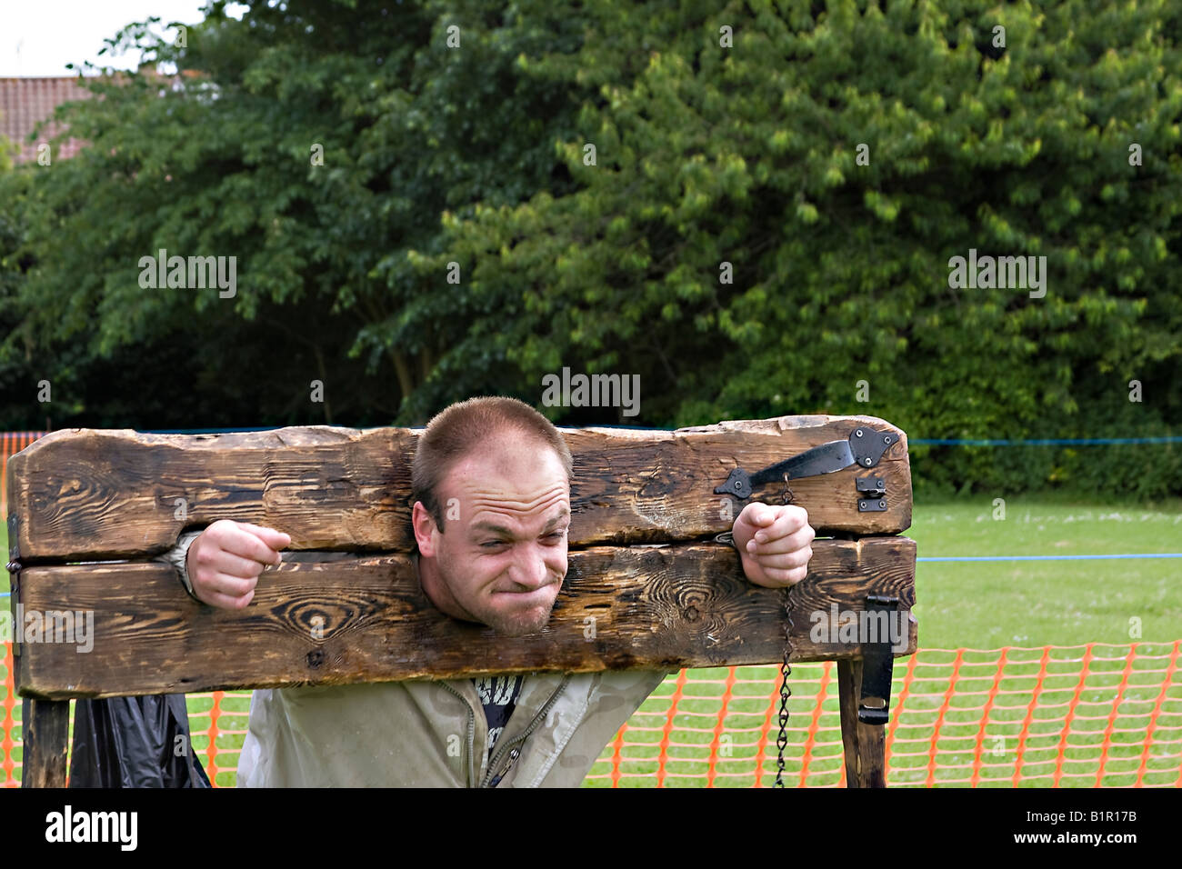 Man in wooden stocks. UK Stock Photo