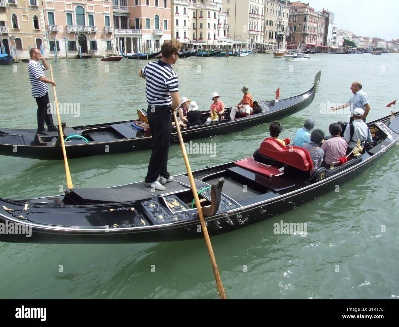 group of oriental tourists on gondola venice italy Stock Photo