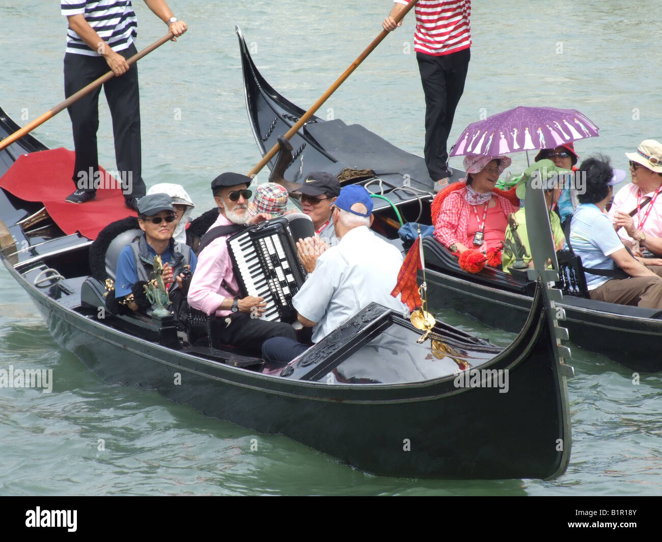 group of oriental tourists on gondola venice italy Stock Photo