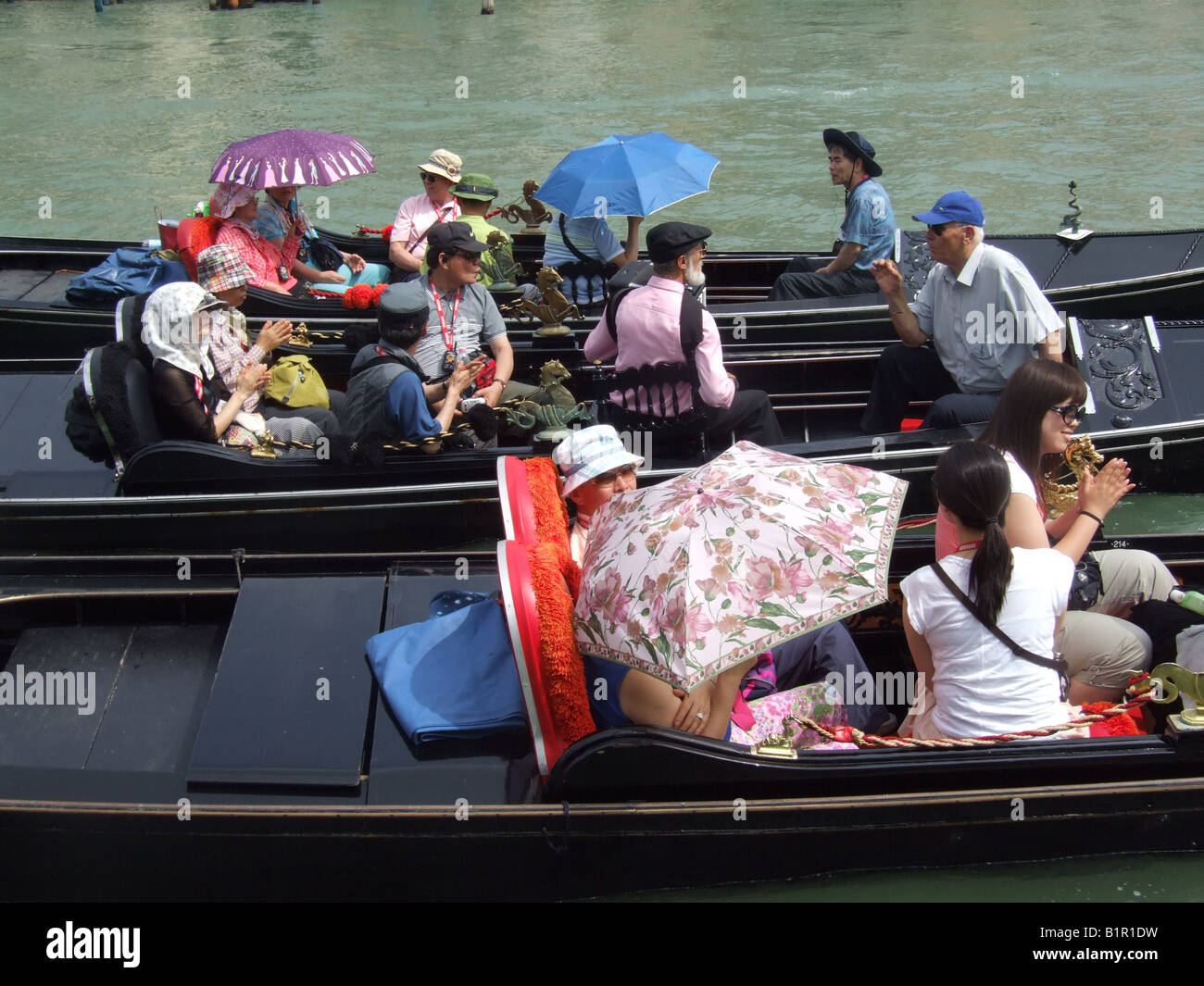 group of oriental tourists on gondola venice italy Stock Photo