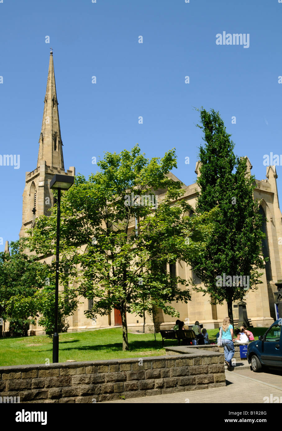 The university church on the Huddersfield university campus with students relaxing in the foreground Stock Photo