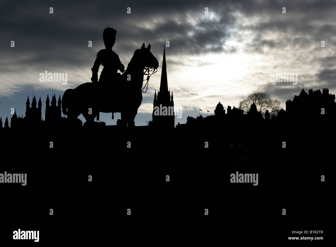 City of Edinburgh, Scotland. Silhouetted view of the Royal Scots Greys Boer War memorial equestrian statue, in Princes Street. Stock Photo