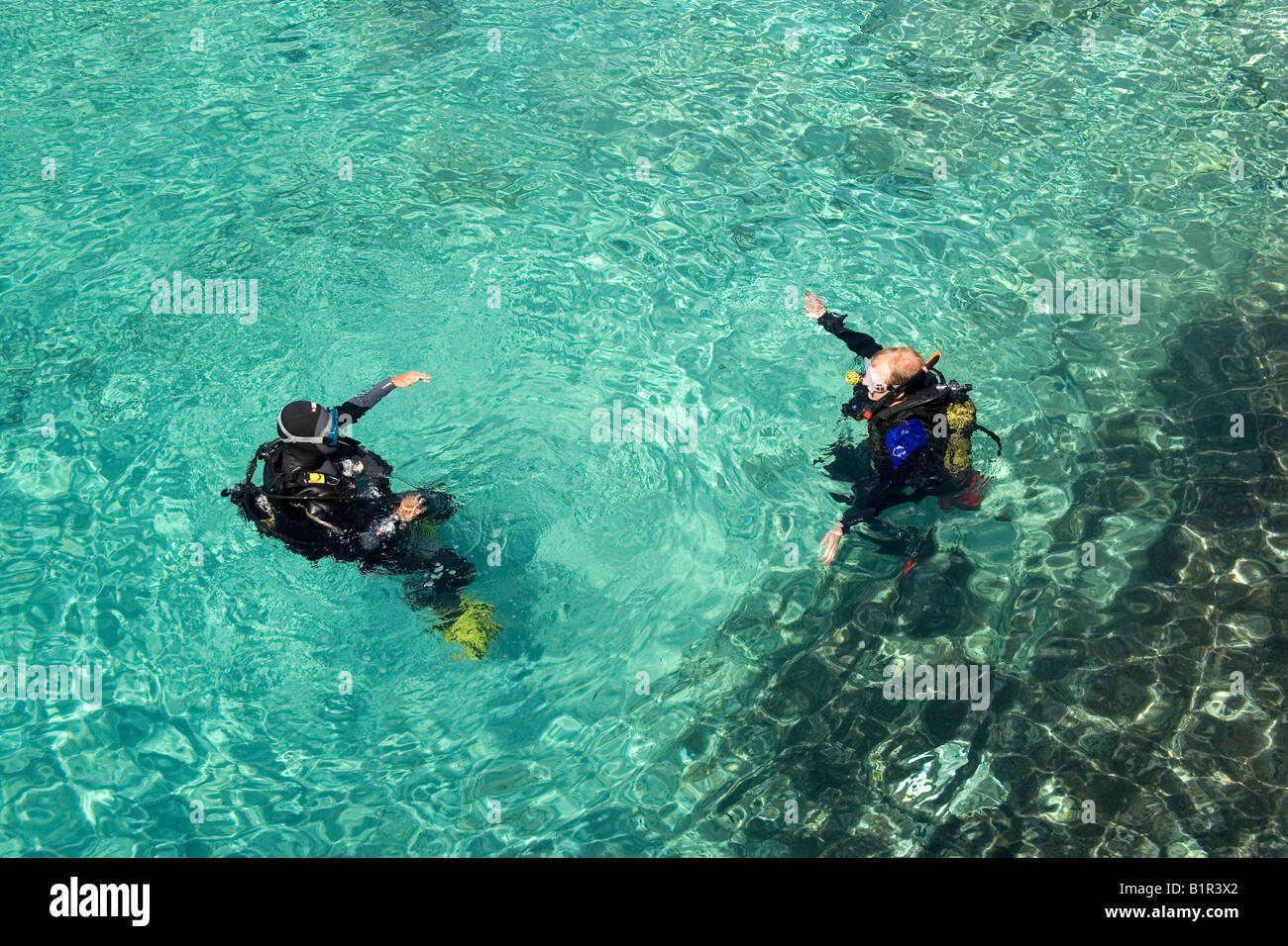 High angle view of two scuba divers in the water, Hondoq Bay, Gozo, Malta Stock Photo