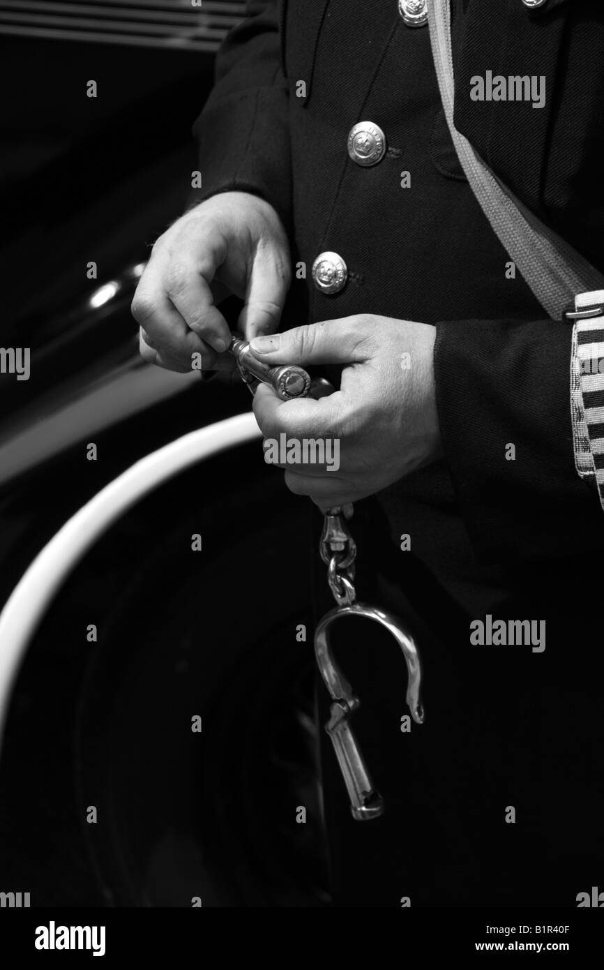 The hands of a policeman with handcuffs. Stock Photo