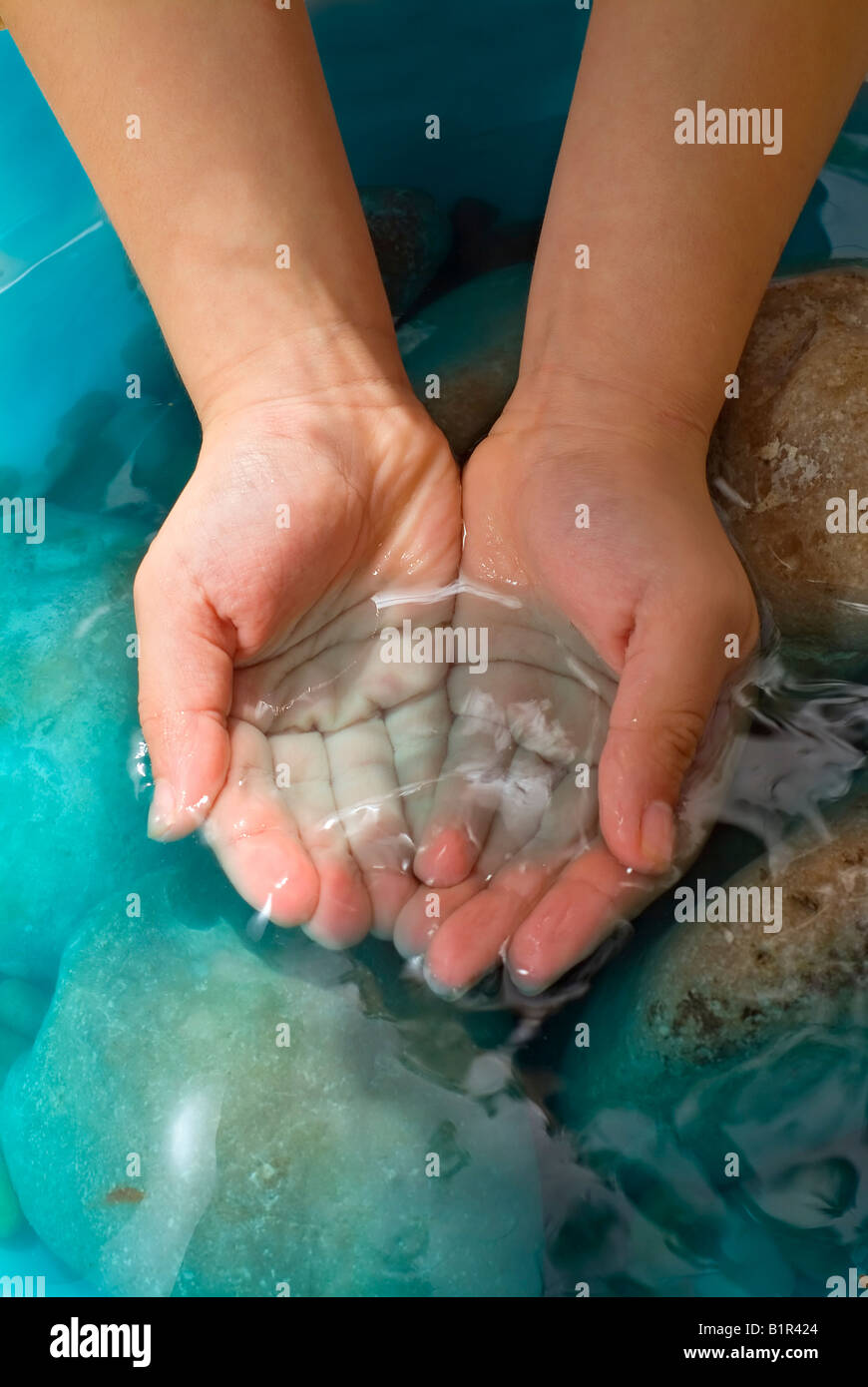 child s hands holding water stones Stock Photo Alamy