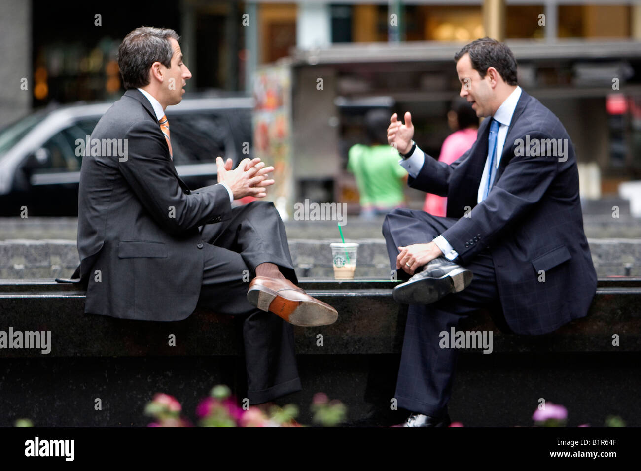 Two businessmen have a discussion in New York City New York USA June 5 2008 Stock Photo