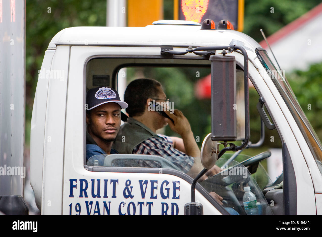 A man looks out the window of a lorry in New York City, New York, USA. Stock Photo