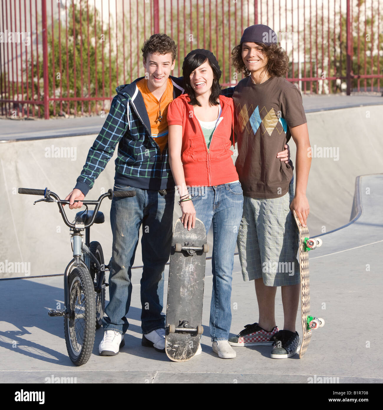 Three Kids Hang Out At The Skatepark Stock Photo Alamy