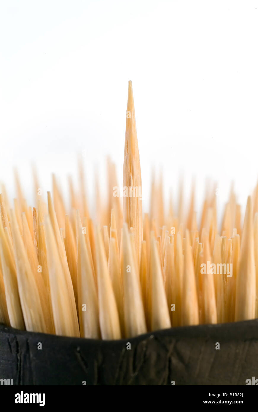 toothpicks in a ceramic container with one sticking out Stock Photo