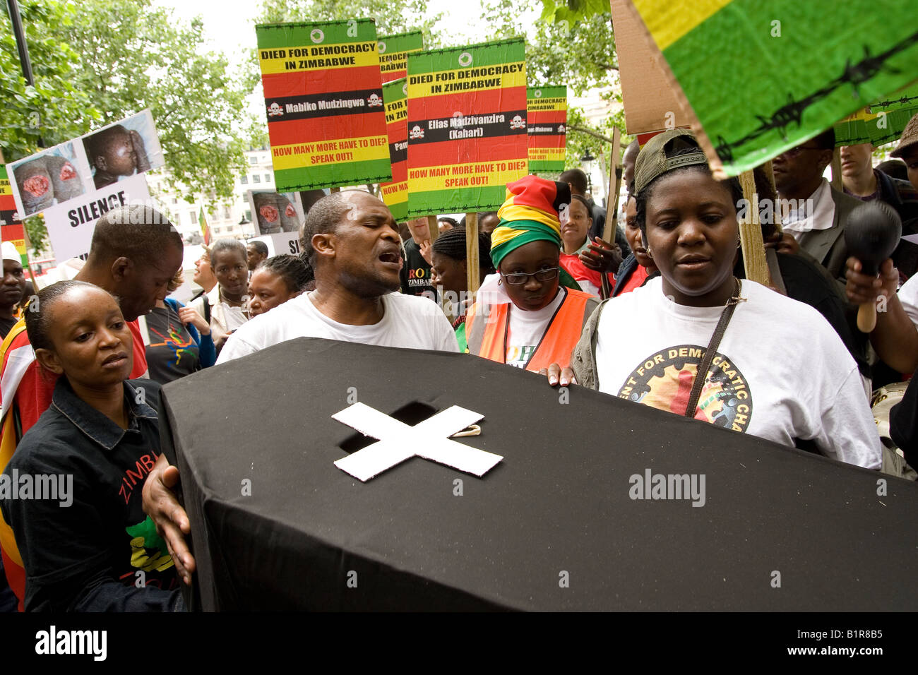 Anti Mugabe protesters carry coffin outside South Africa House London Stock Photo