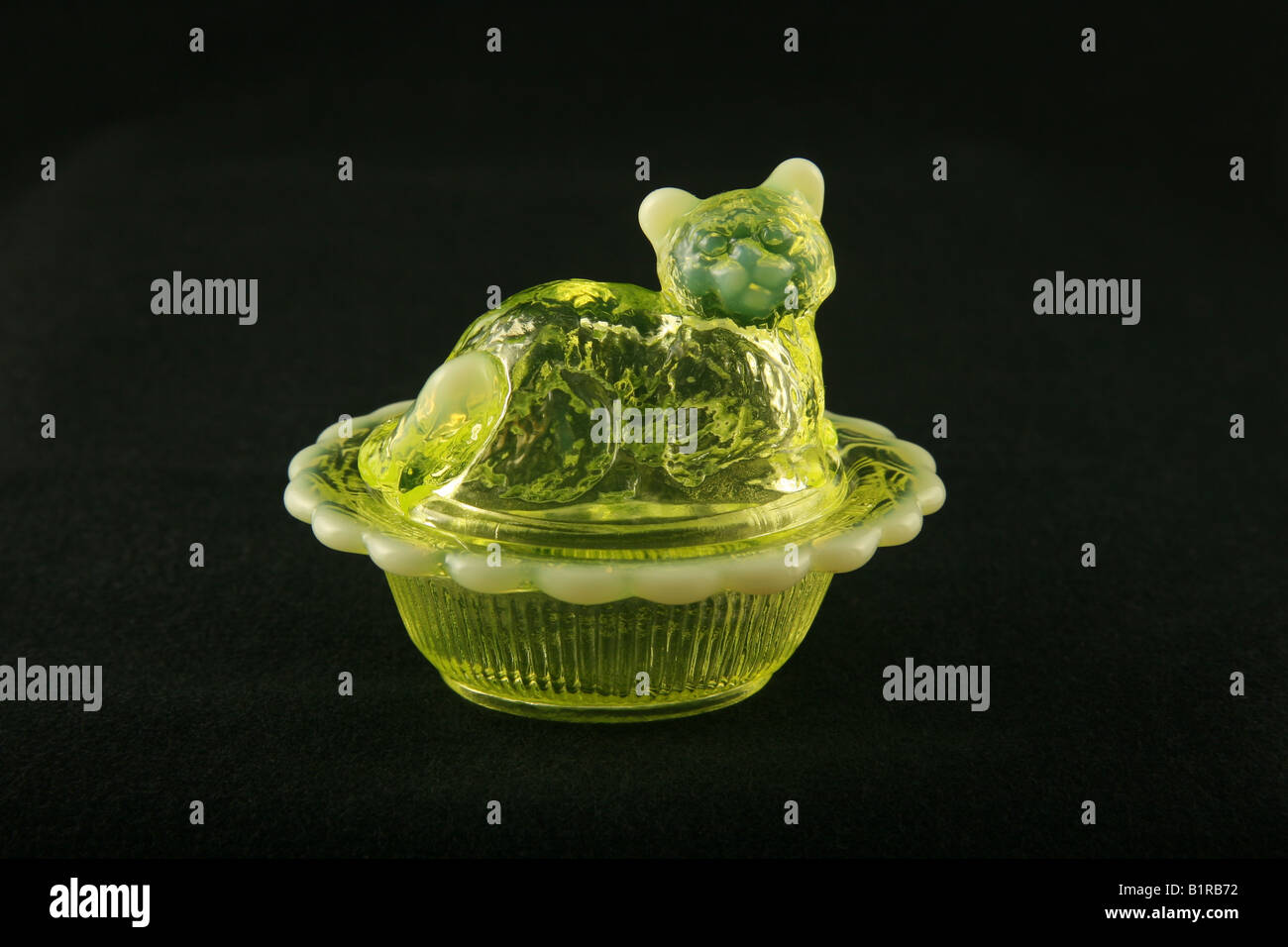 Uranium or vaseline glass cat in a basket shown under normal lighting Stock  Photo - Alamy