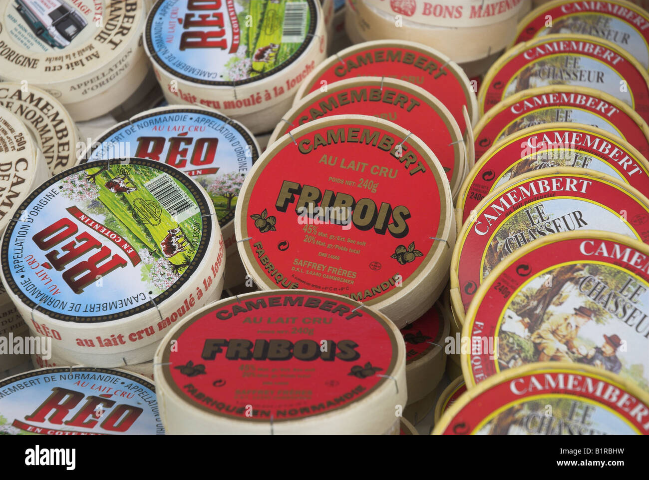 A selection of camembert cheeses for sale on a market stall in the
