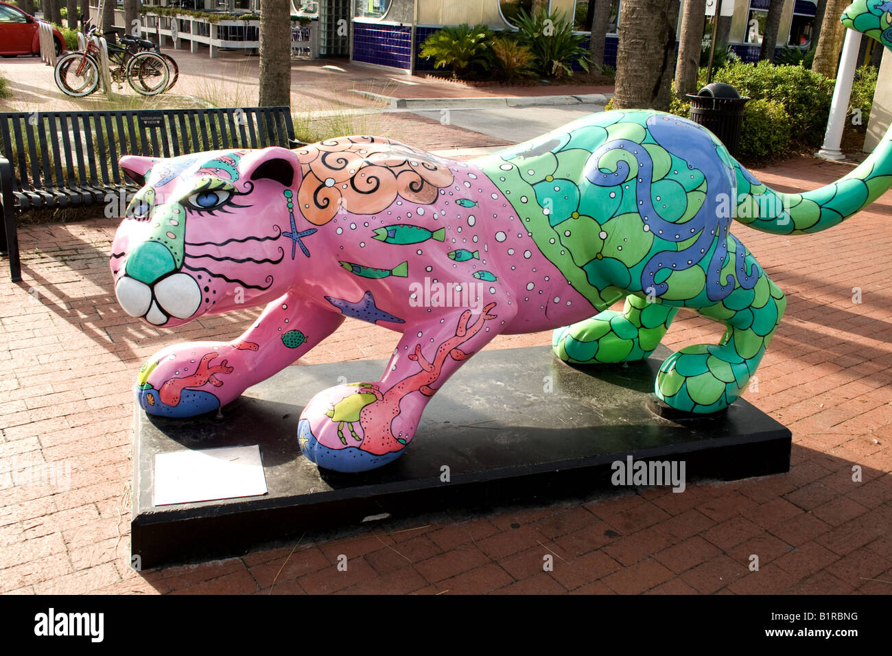 Artistic crouching multi-colored cat on a small pedestal in a town square in Atlantic  Beach, Florida Stock Photo