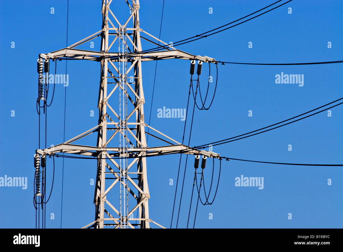 Energy Industry / Electricity. A High Voltage Transmission Tower and Power Lines. Stock Photo