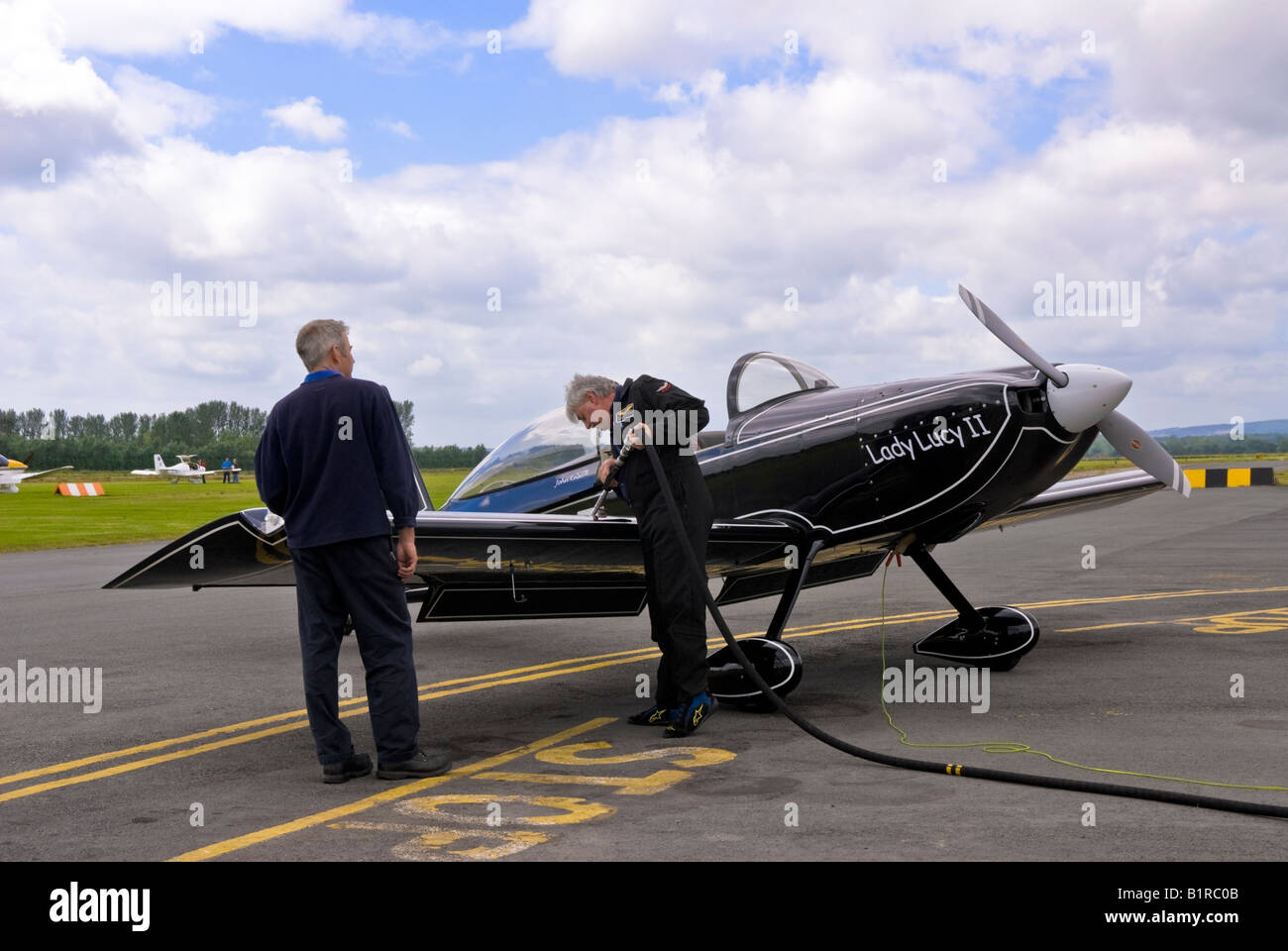 Refueling a light aircraft at Herefordshire Aero Club air race weekend. Re-fueling a small plane with AVGAS, UK. Stock Photo