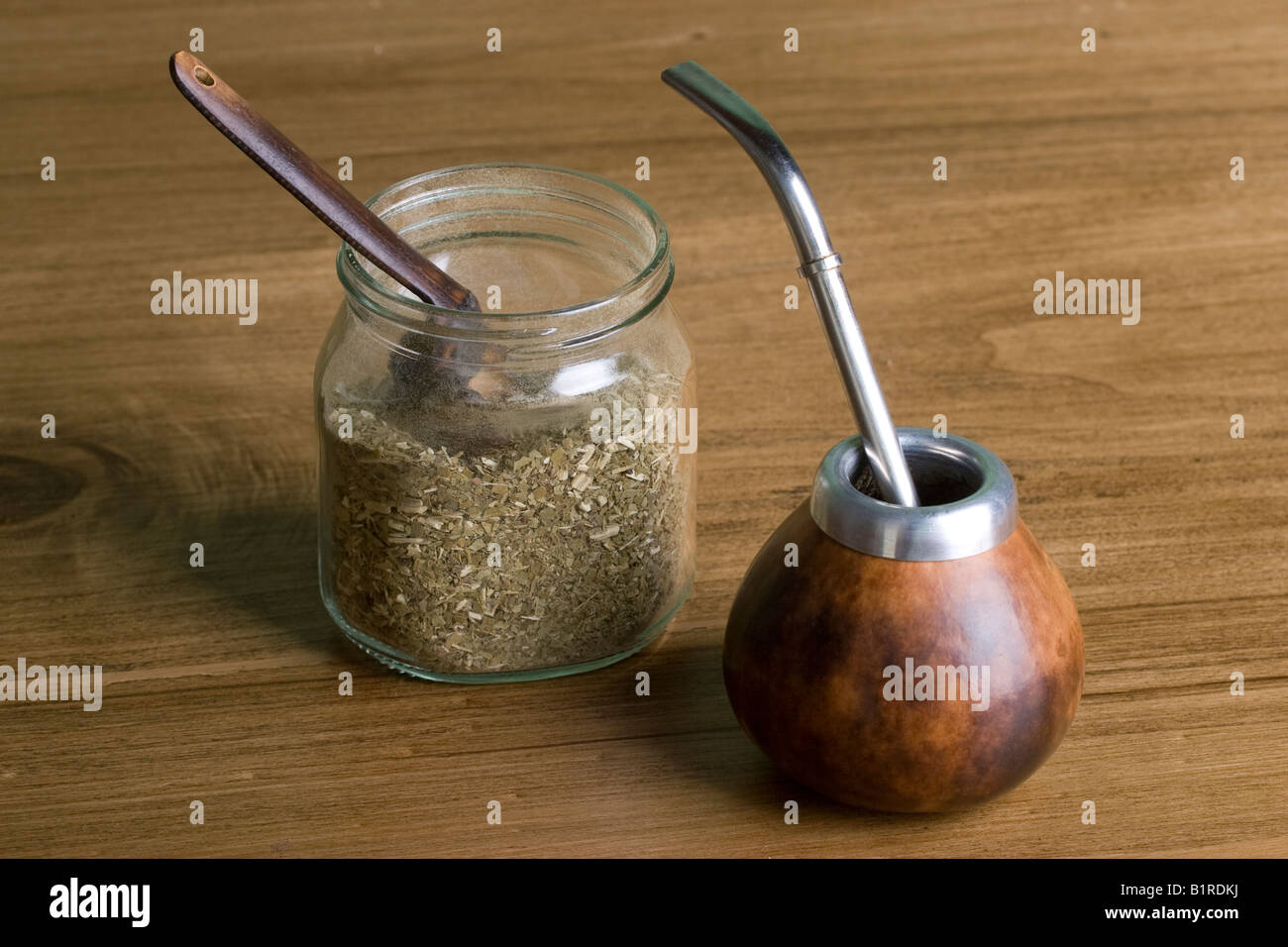 Calabash mate gourd with metal bombilla straw and yerba mate in a flask
