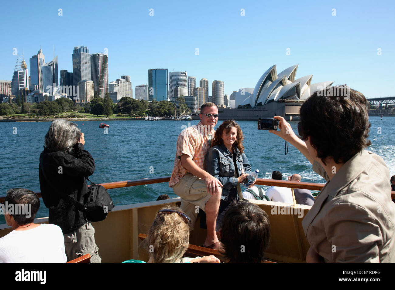 Tourists take in the sights on Sydney Harbour Manly Ferry New South Wales Australia Stock Photo