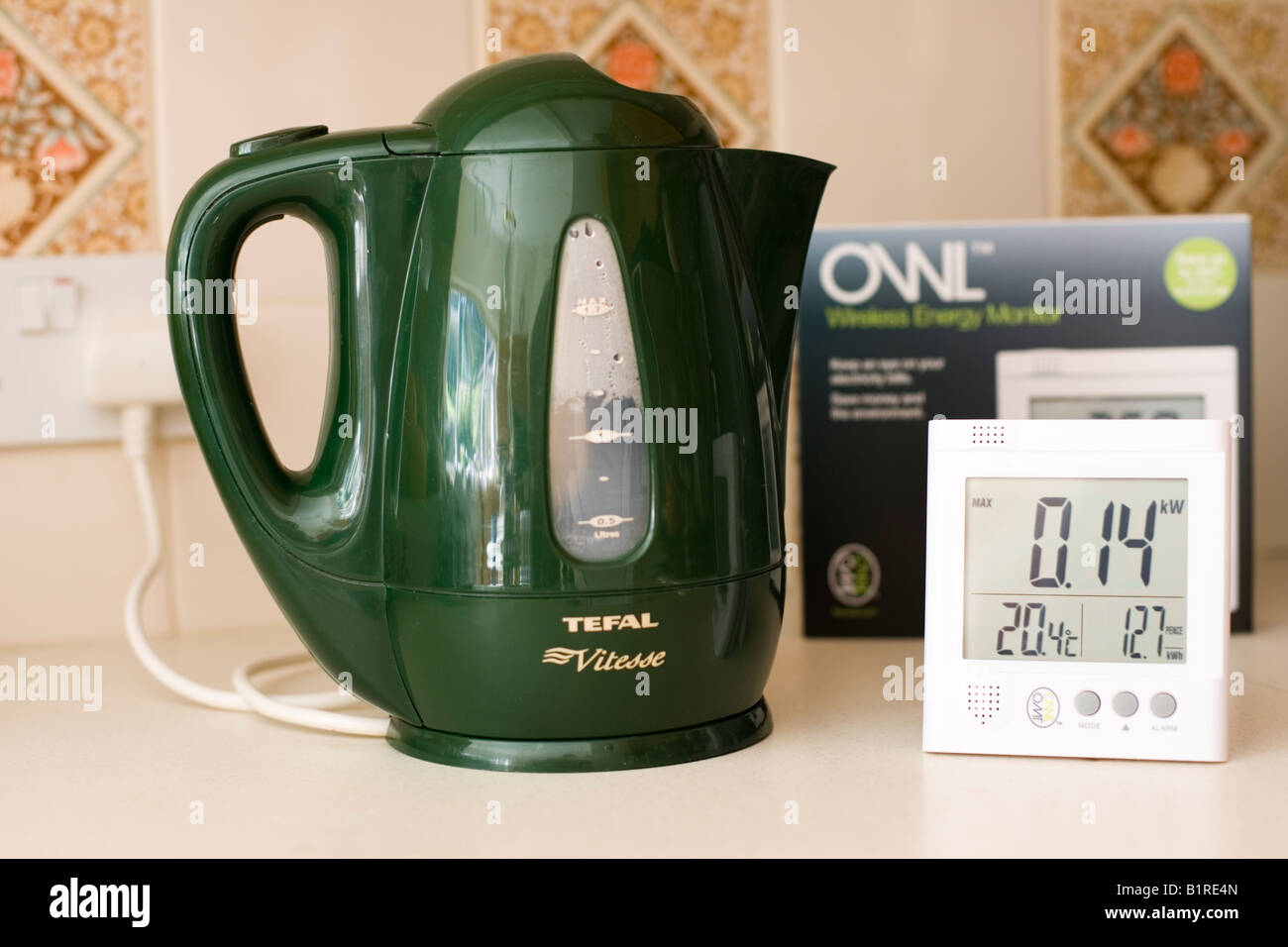Owl energy monitor measuring electricity use of green kettle UK Stock Photo