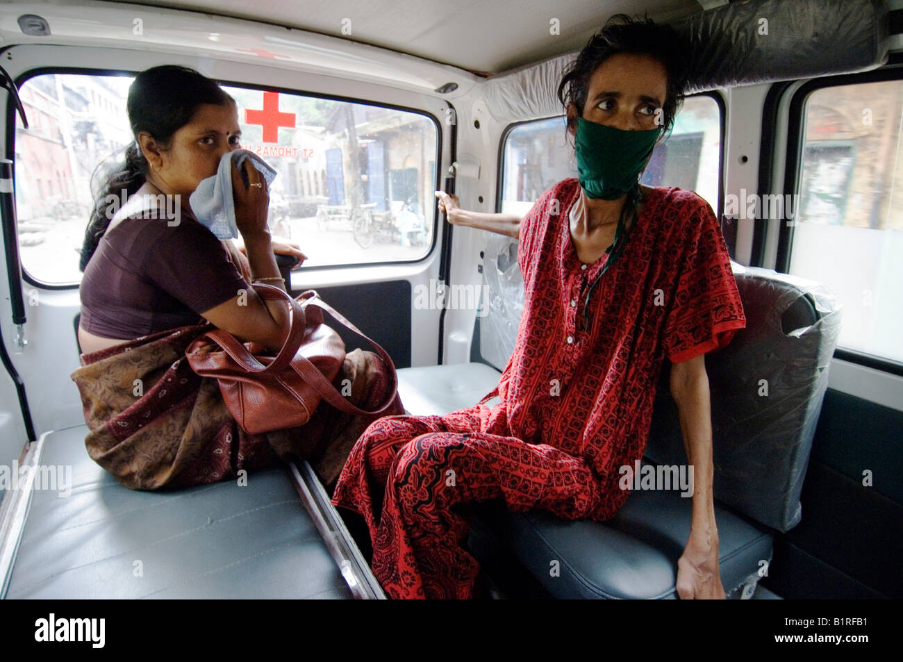 Najira Begum, 35, diagnosed with multi-resistant tuberculosis, in an ambulance with a female social worker on the way to an x-r Stock Photo