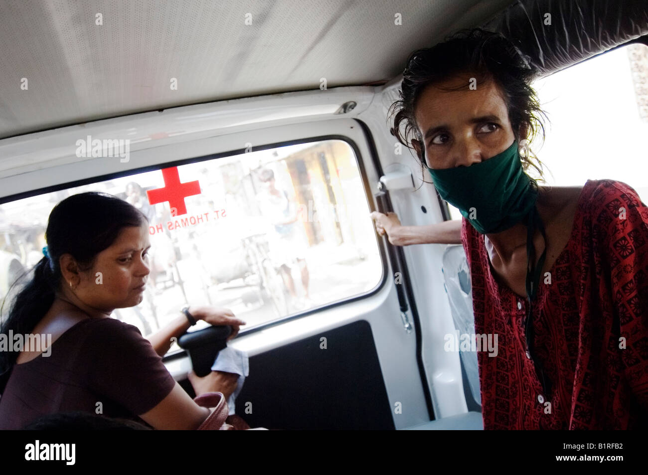 Najira Begum, 35, diagnosed with multi-resistant tuberculosis, in an ambulance with a female social worker on the way to an x-r Stock Photo