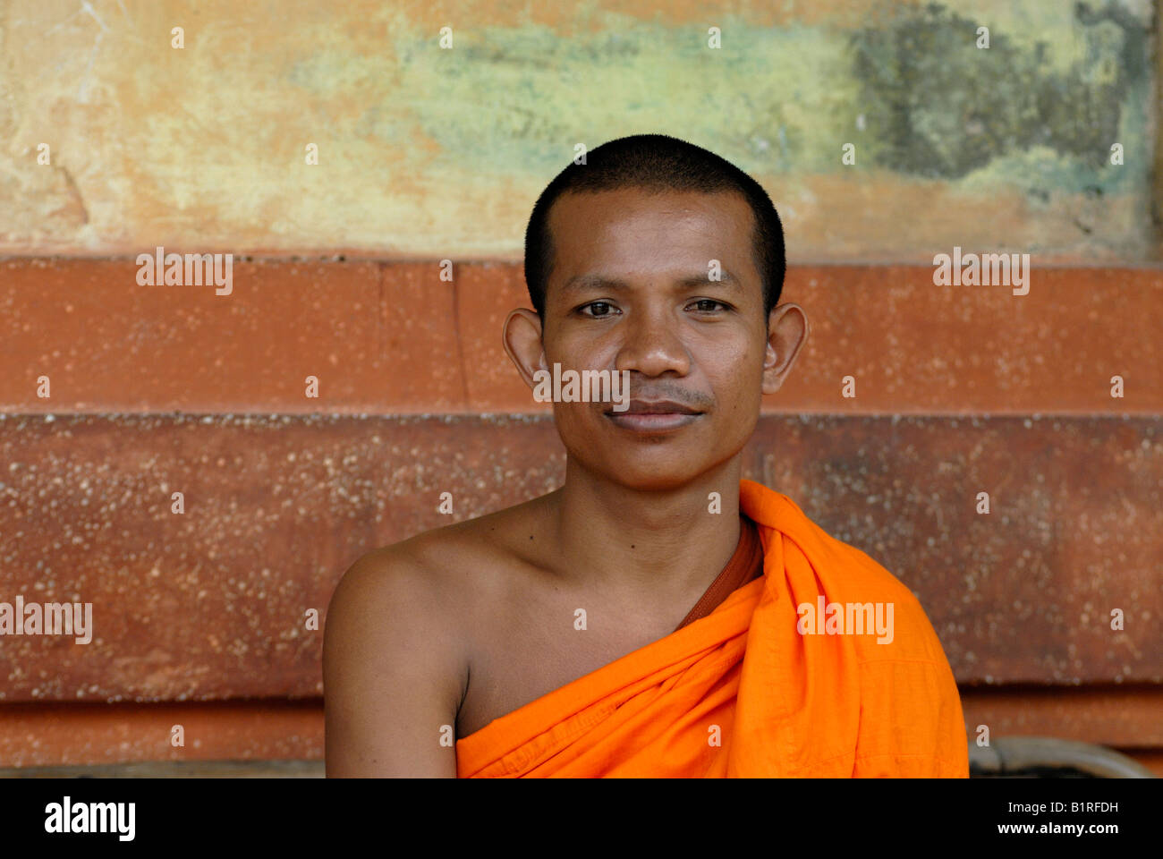 Smiling Buddhist monk wearing an orange robe, Angkor, Siem Reap Stock