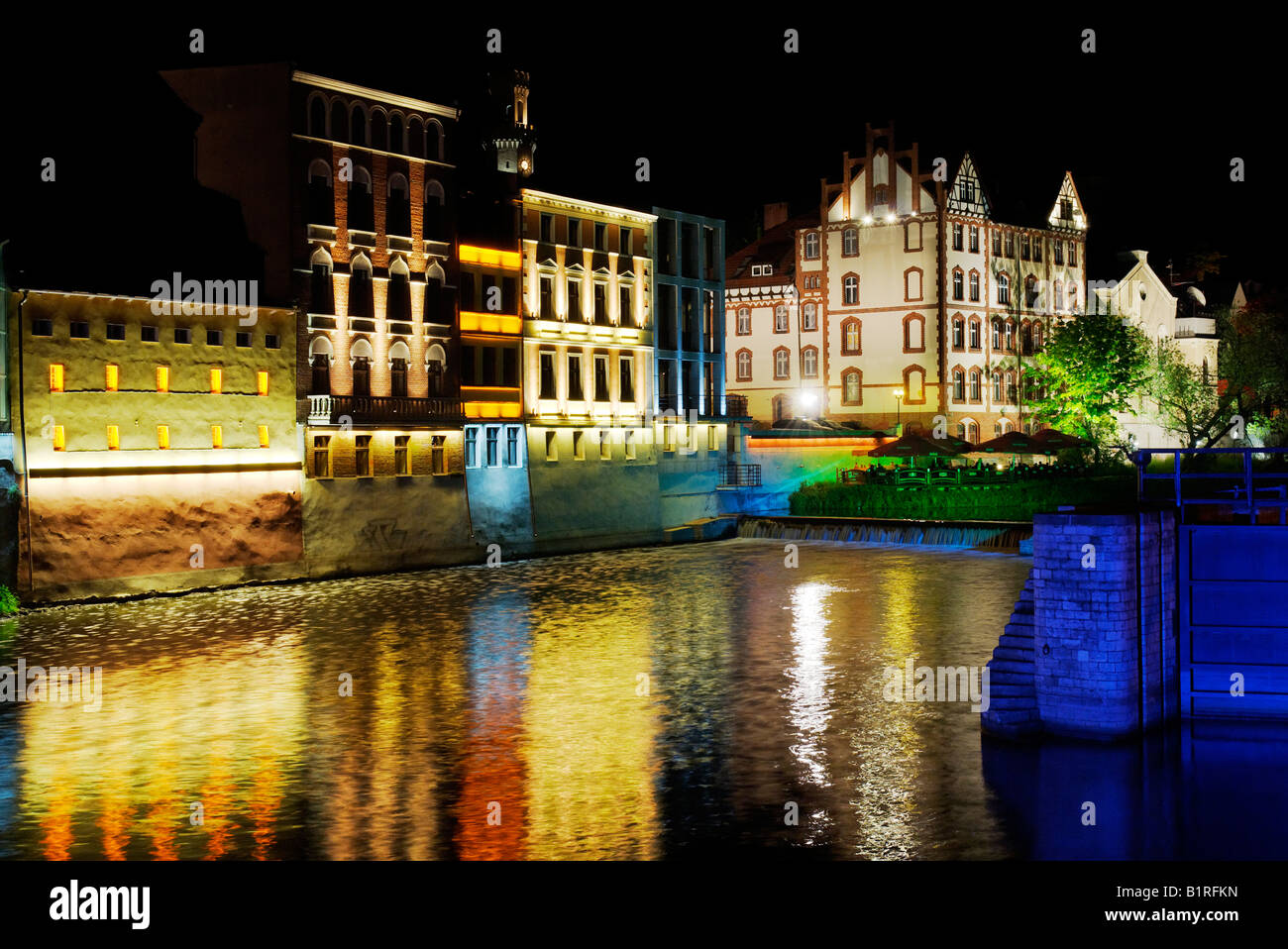 Facades, lit up, on the River Oder in Opole, Silesia, Poland, Europe Stock Photo