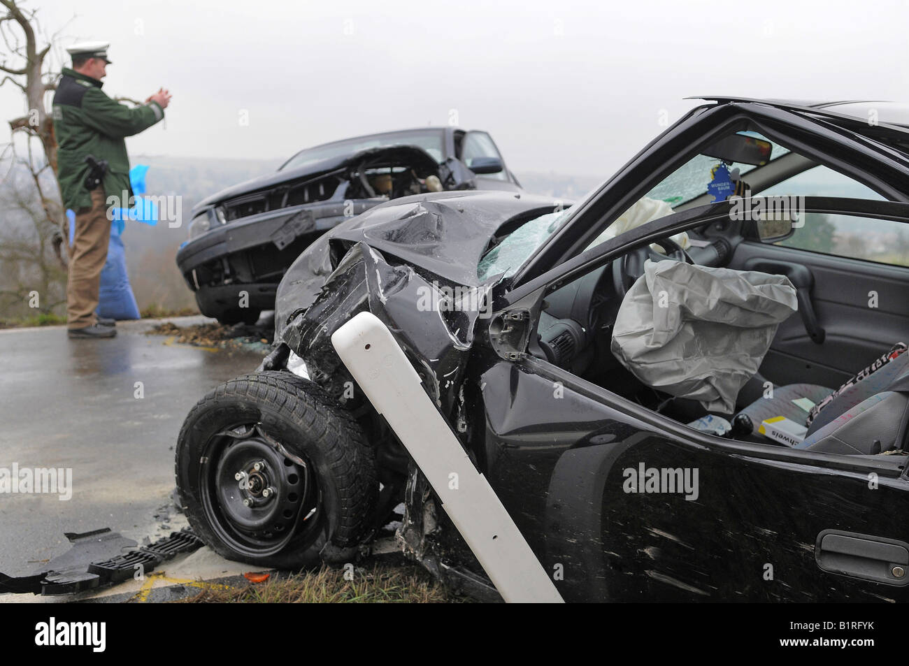 Police officer photographing car wrecks after a car accident for the acquisition of accident data, Nuertingen, Esslingen Region Stock Photo