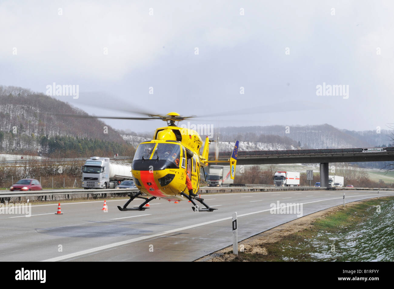 The ADAC German auto club air rescue helicopter Christoph 22 taking off to hospital from autobahn or motorway A8 after a deadly Stock Photo