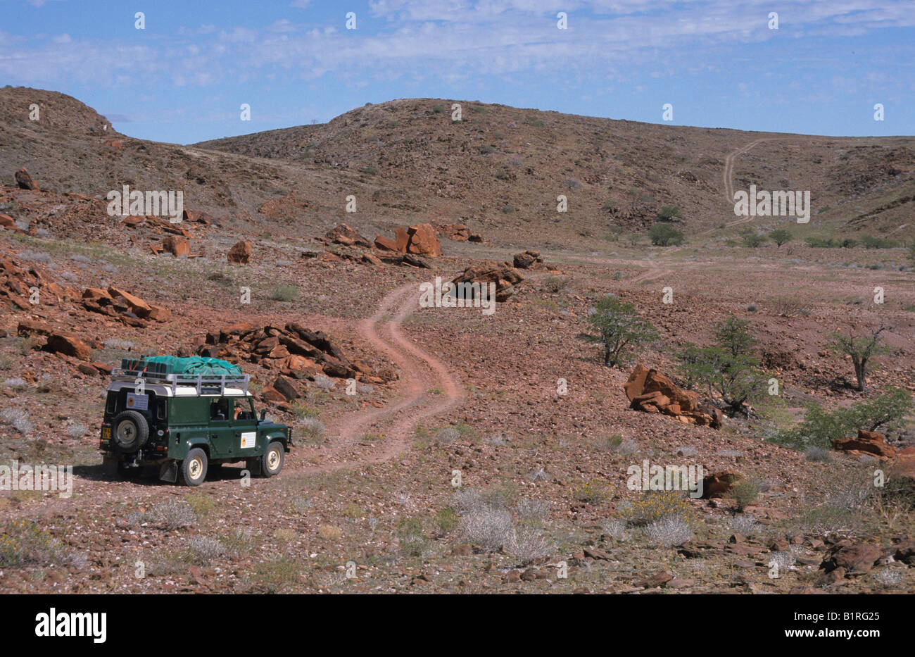 Land Rover in stony desert landscape near the Messum Crater, Namibia, Africa Stock Photo