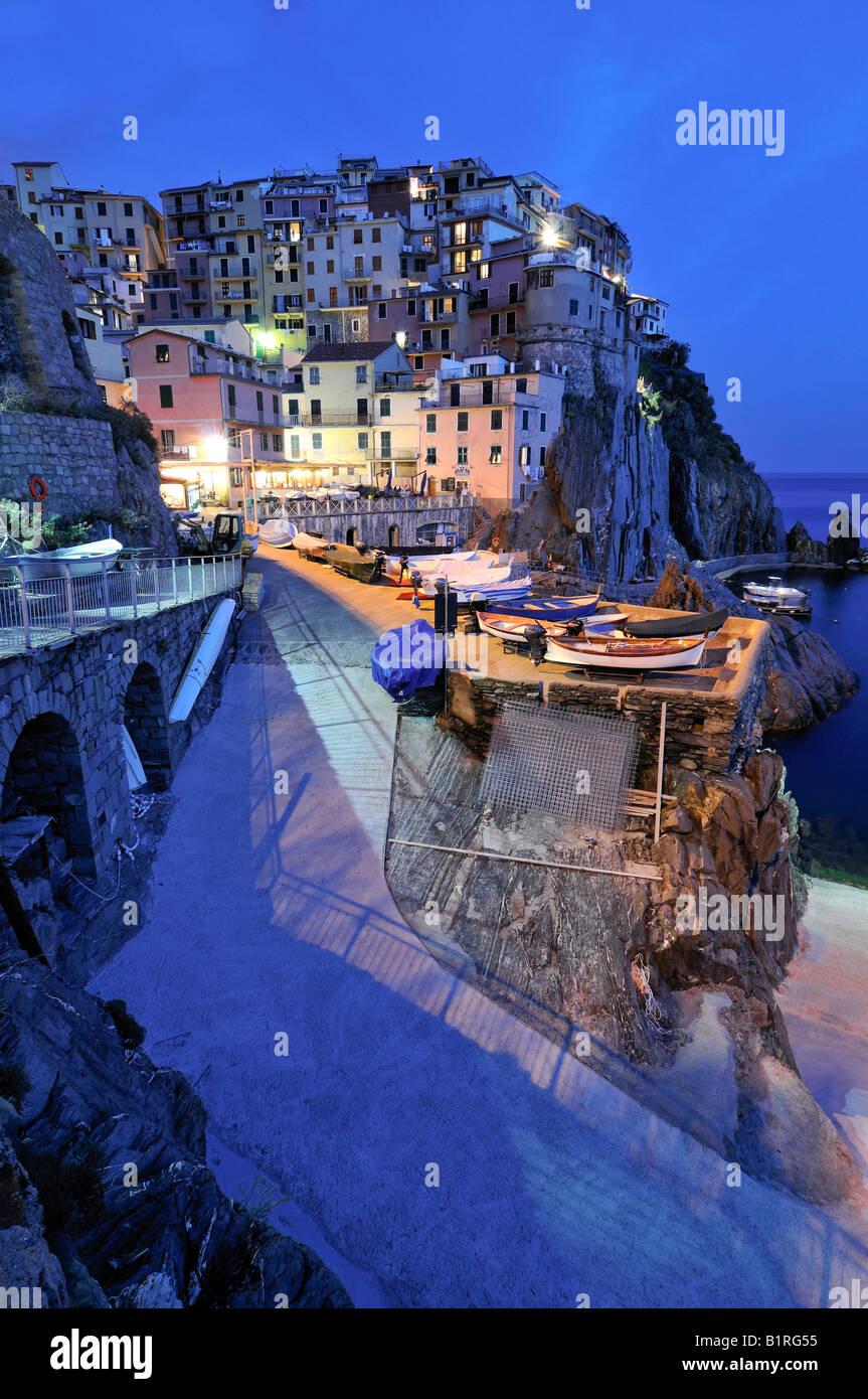 Village of Manarola nestled atop steep coastline at dusk, Liguria, Cinque Terre, Italy, Europe Stock Photo