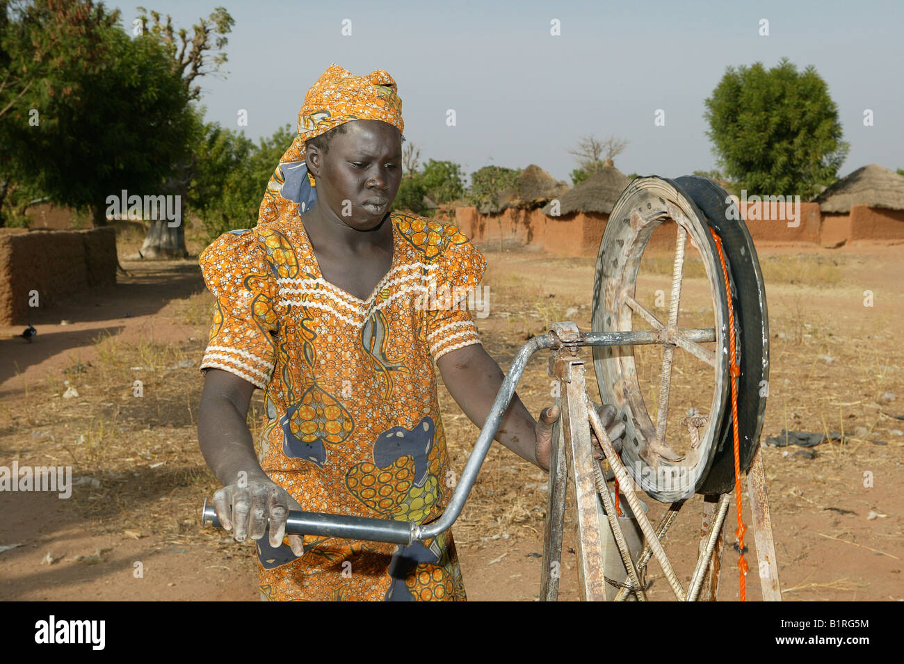 Woman operating a wheeled well, Pakete, Cameroon, Africa Stock Photo