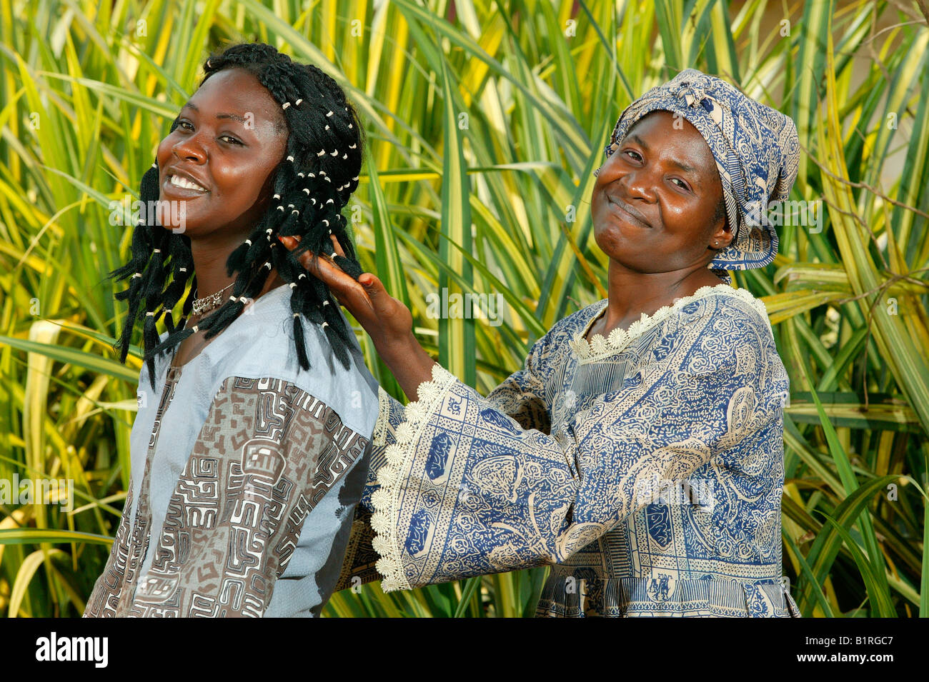 Seamstresses of an HIV help group modelling self-made clothes, Bafut, Cameroun, Africa Stock Photo