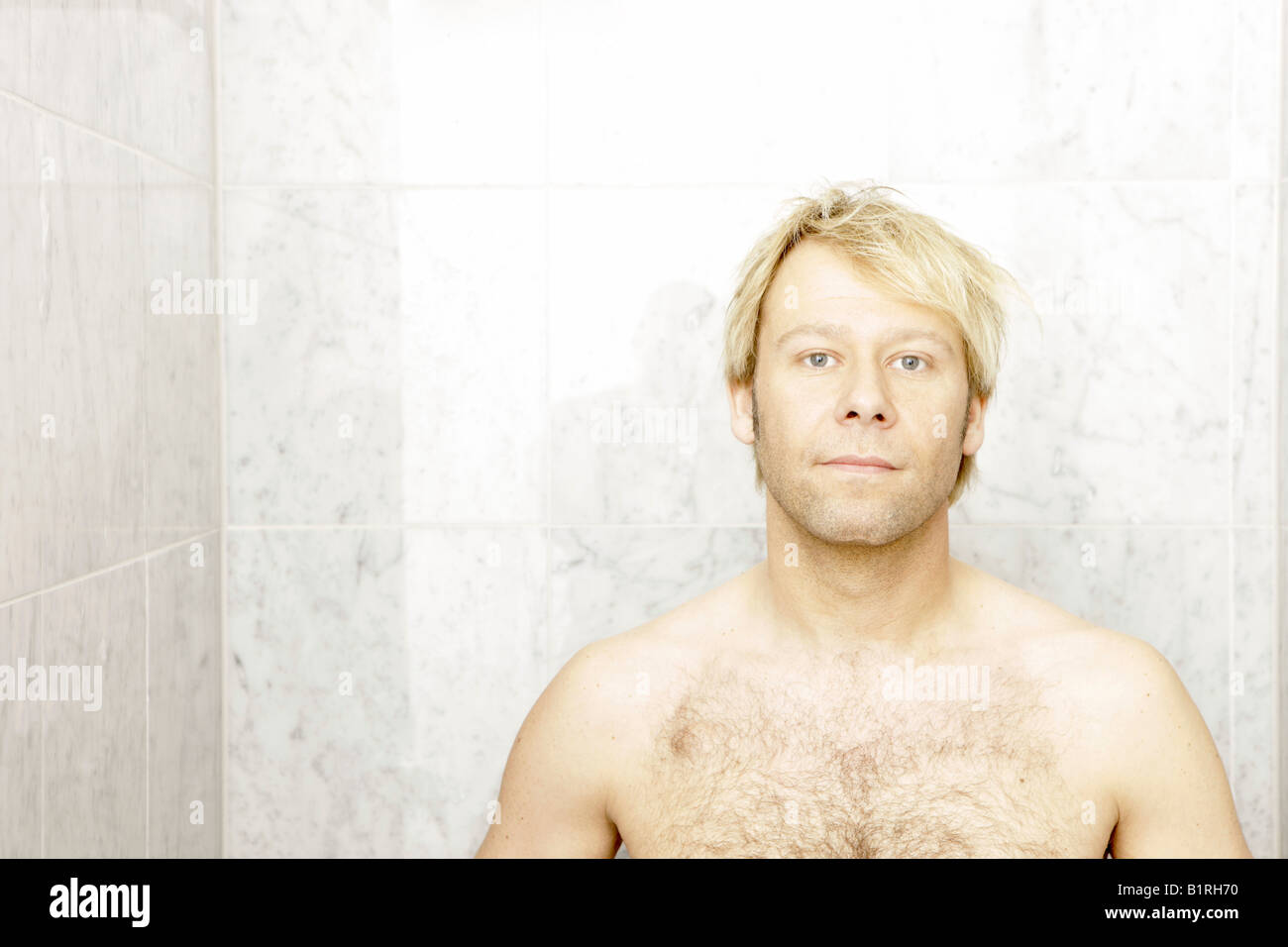 Blonde man in the shower Stock Photo