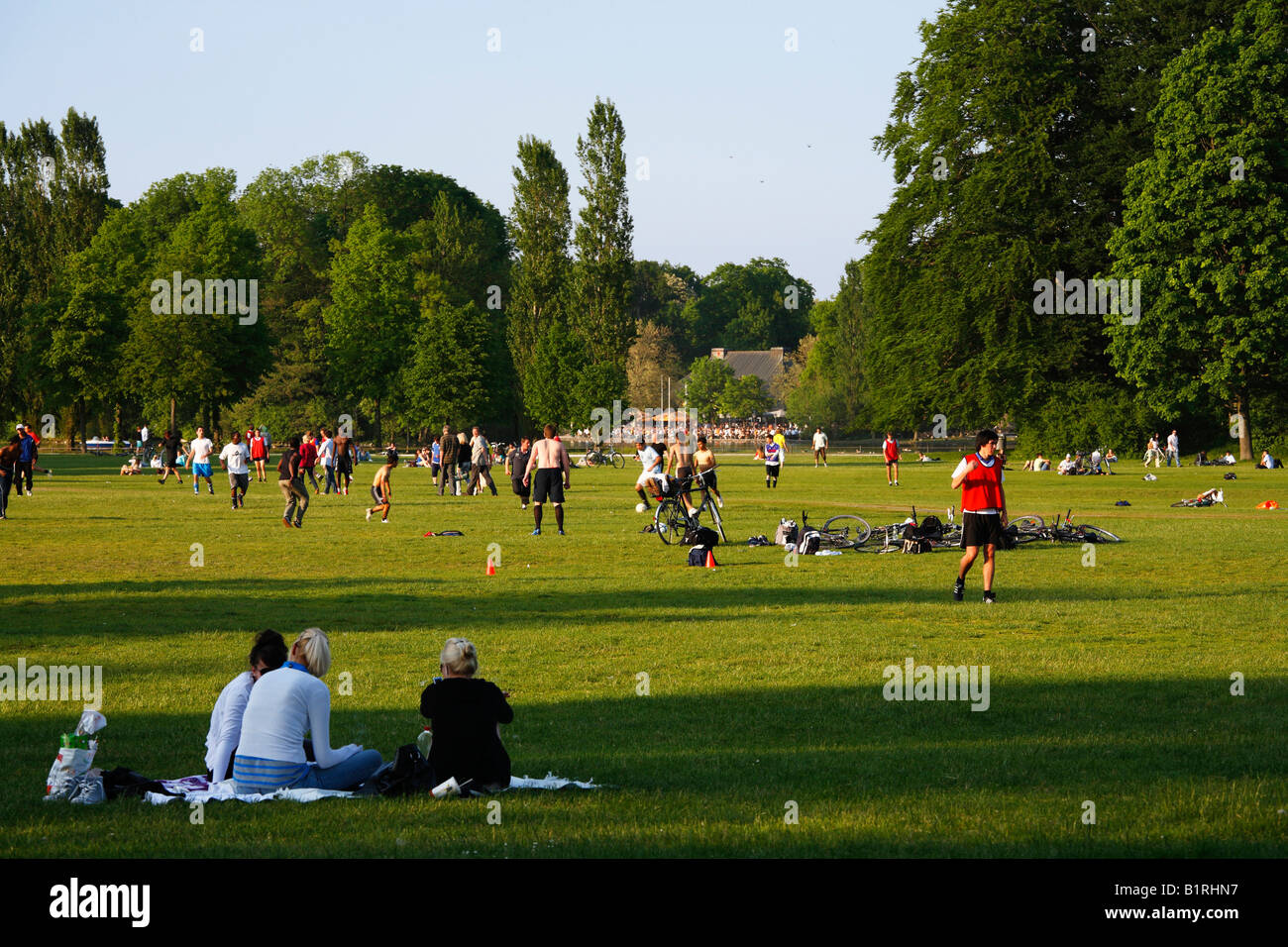 Playing football in the Englischer Garten, English Garden on Lake Kleinhesseloher See, Munich, Upper Bavaria, Germany, Europe Stock Photo