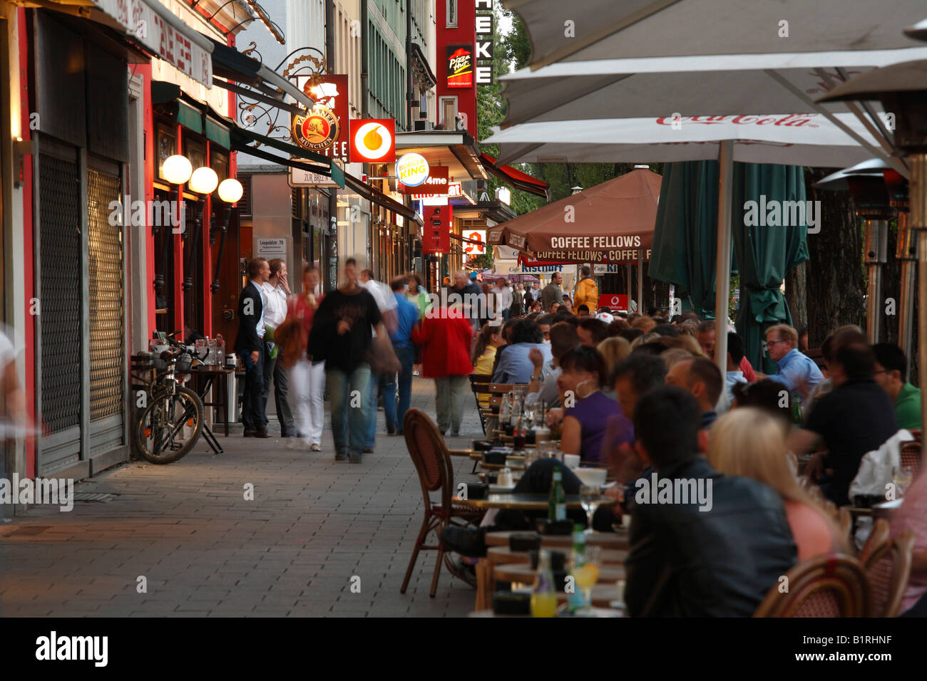 Street cafes on Leopoldstrasse Street in the evening, Schwabing, Munich, Bavaria, Germany, Europe Stock Photo