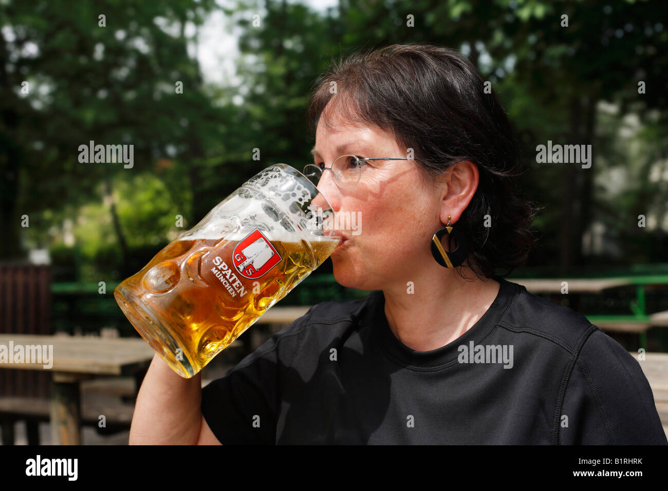 Woman drinking a litre of Spaten brand beer, Taxisgarten Beer Garden, Munich, Bavaria, Germany, Europe Stock Photo