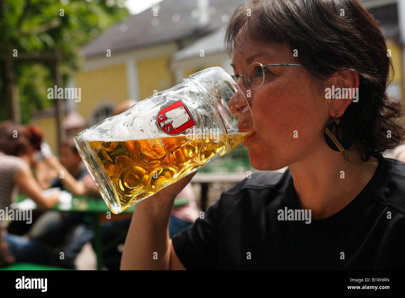 Woman drinking a litre of Spaten brand beer, Taxisgarten Beer Garden, Munich, Bavaria, Germany, Europe Stock Photo