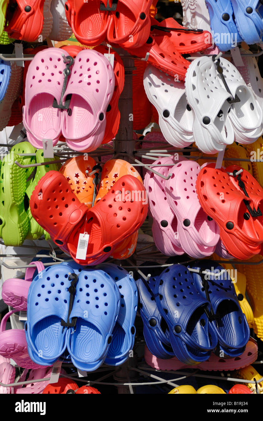 Crocs hung up on a stand, Germany, Europe Stock Photo