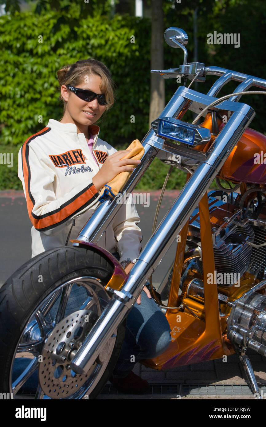 Woman washing a motorcycle Stock Photo