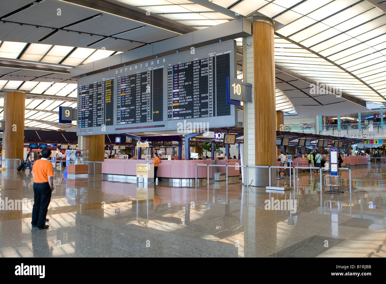 Departure hall, departure board and check-in counters at Changi Airport, Singapore, Southeast Asia Stock Photo
