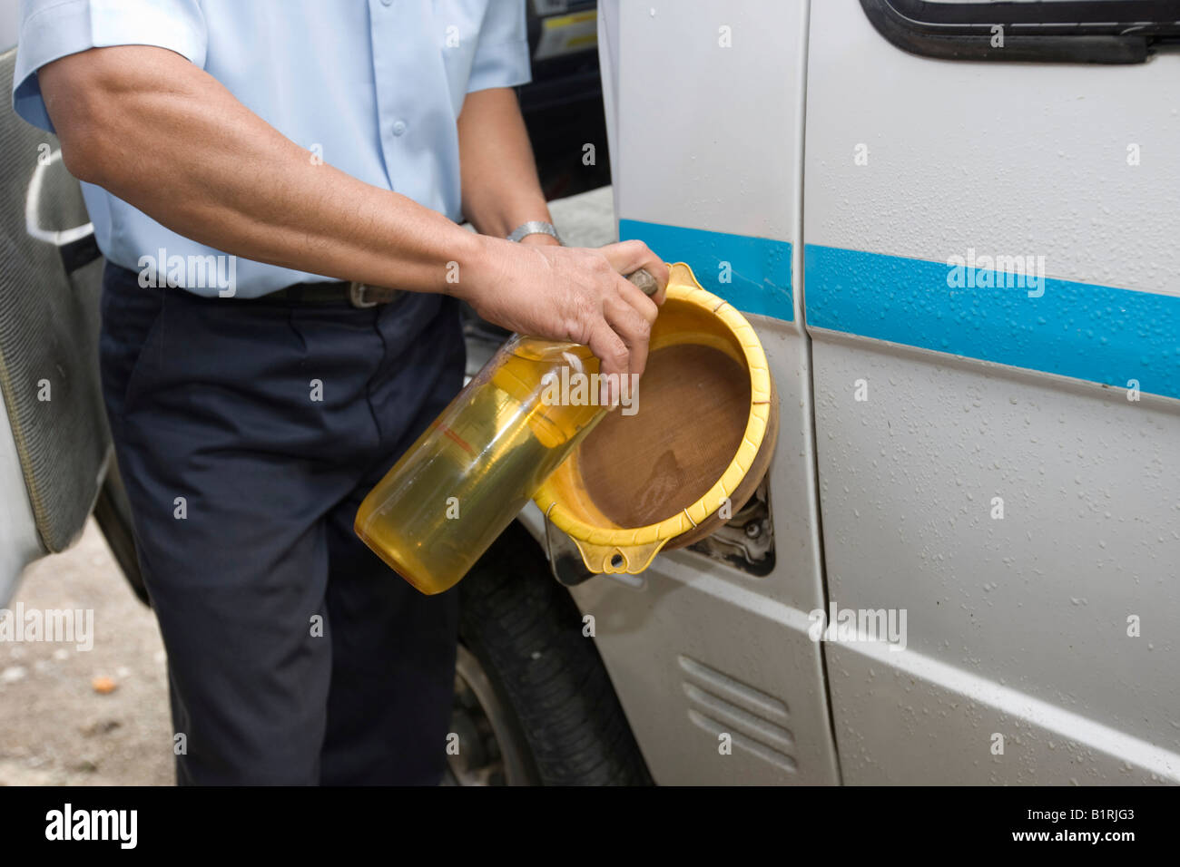 Typical petrol station on the streets of Asia, petrol is stored in glass bottles from which it is sold and poured into the petr Stock Photo