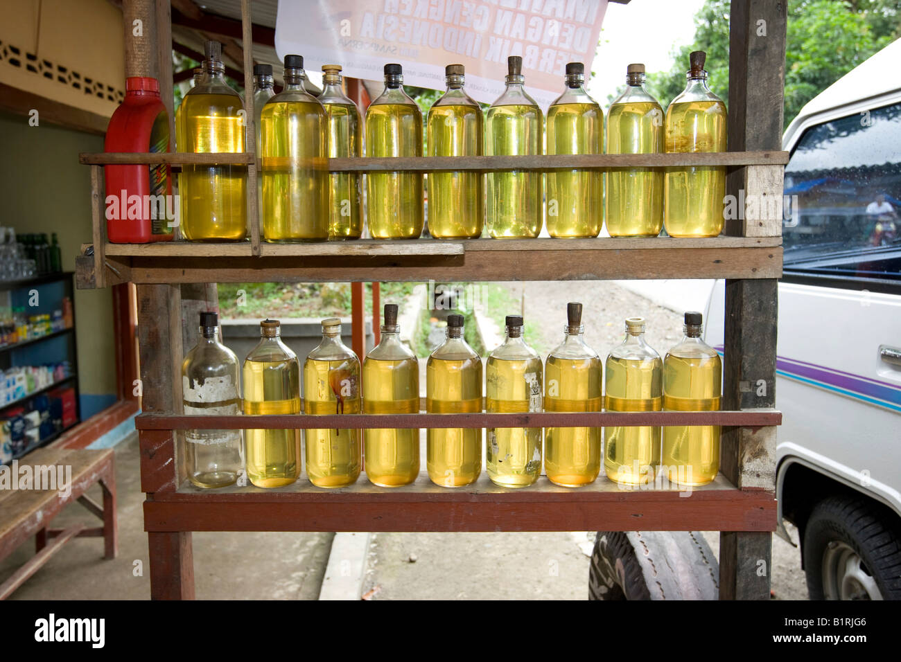 Typical petrol station on the streets of Asia, petrol is stored in glass bottles from which it is sold and poured into the petr Stock Photo