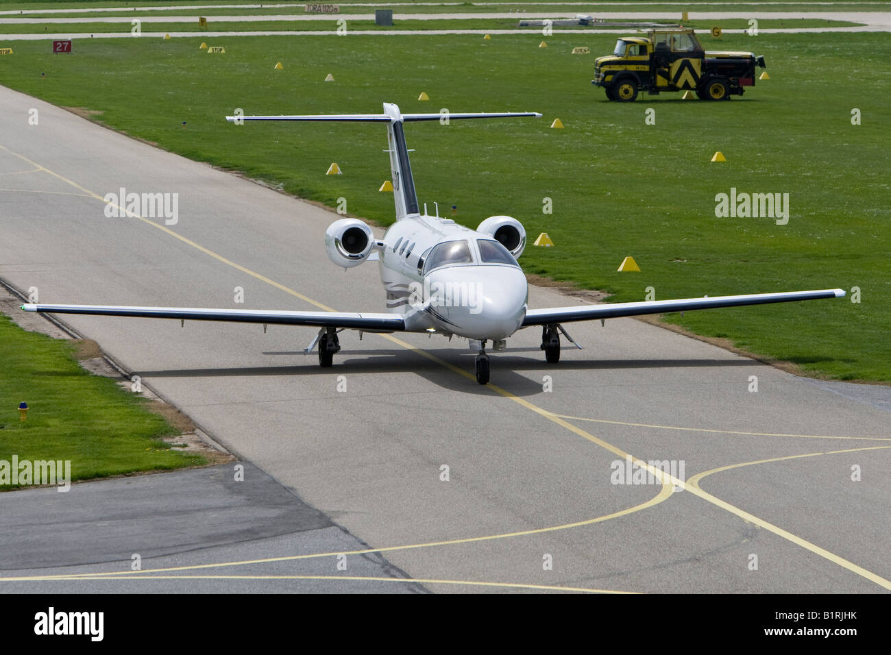 Small, twin-engined business jet taxiing on the runway of Mannheim Airport, Baden-Wuerttemberg, Germany, Europe Stock Photo