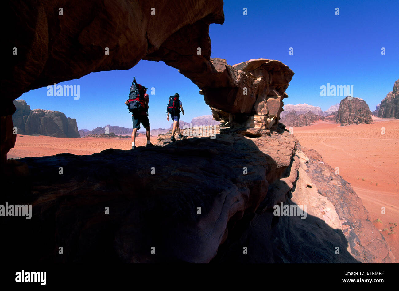 Trekking, stone arch, Wadi Rum, Jordan, Asia Stock Photo