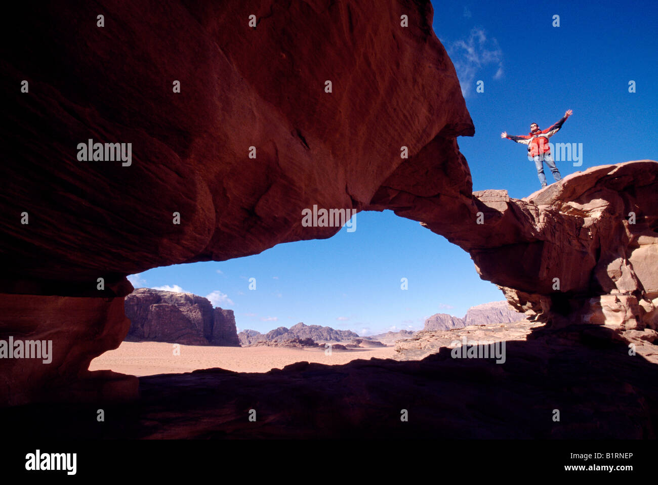 Trekking, stone arch, Wadi Rum, Jordan, Asia Stock Photo