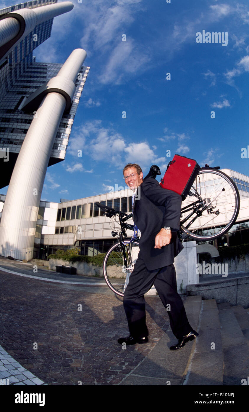 Businessman, biker, Hypo-Haus, Bogenhausen, Munich, Bavaria, Germany Stock Photo