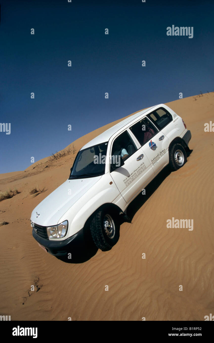 Toyota Land Cruiser, sport utility vehicle, SUV, driving down a sand dune, Wahiba Sands, Oman, Arabian Peninsula, Middle East Stock Photo