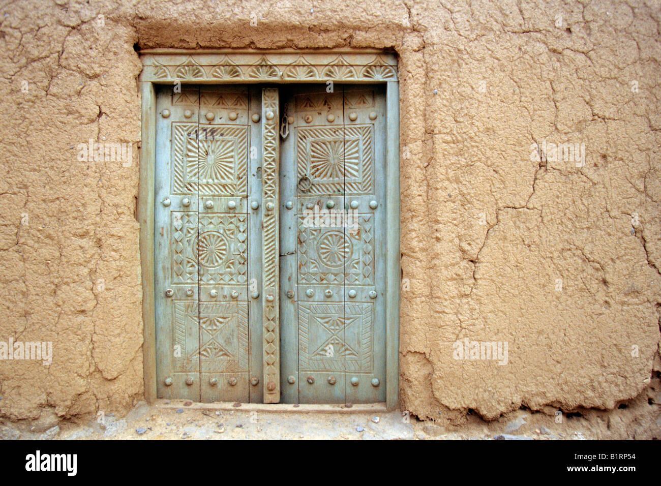 Old door in an earth house, adobe, in Al Hamra, Oman, Arabian Peninsula, Middle East Stock Photo