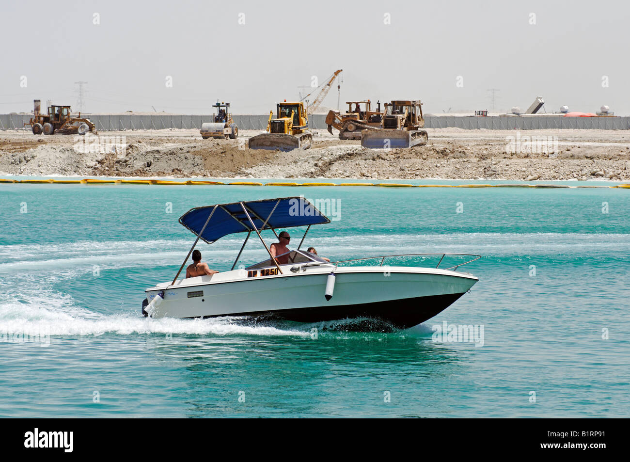 Water sports in front of a large building site in Abu Dhabi, United