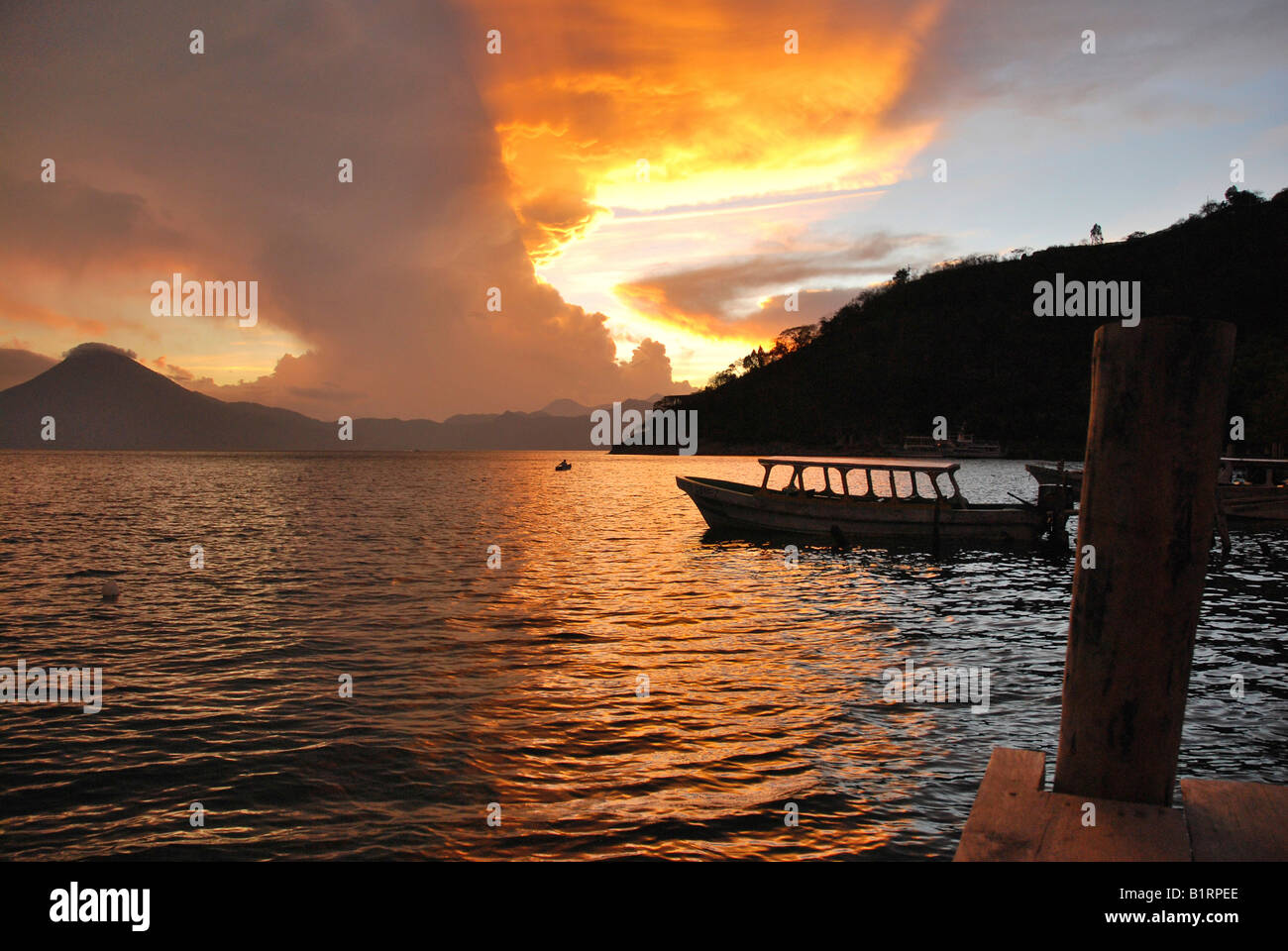 Sunset, back light, dramatic clouds, boat, Lake Atitlán, Guatemala, Central America Stock Photo